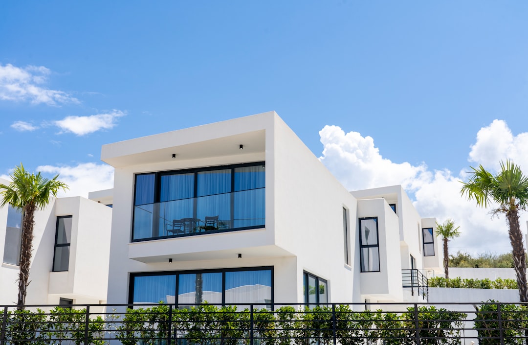 The beautiful, modern exterior of a Gulf Coast home with a pristine new roof, shown on a clear and sunny day, representing security and peace of mind.